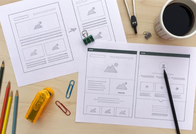 website wireframes sketched out on white paper